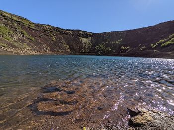 Scenic view of lake against clear blue sky