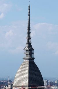 Spire of church in city against sky