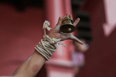 Close-up of hand holding bell