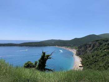 Scenic view of sea against clear blue sky