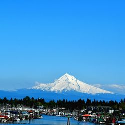 Scenic view of snowcapped mountains against blue sky