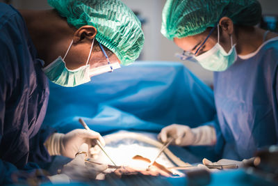 Surgeons operating patient in hospital