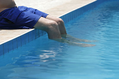 Low section of woman swimming in pool