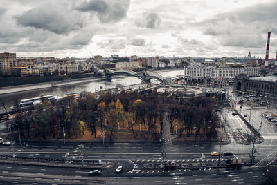 High angle view of city by river against sky