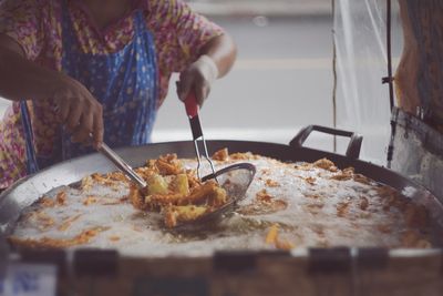 Midsection of woman preparing food