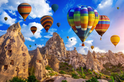 Low angle view of hot air balloons flying in sky