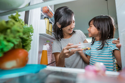 Women standing by food on table