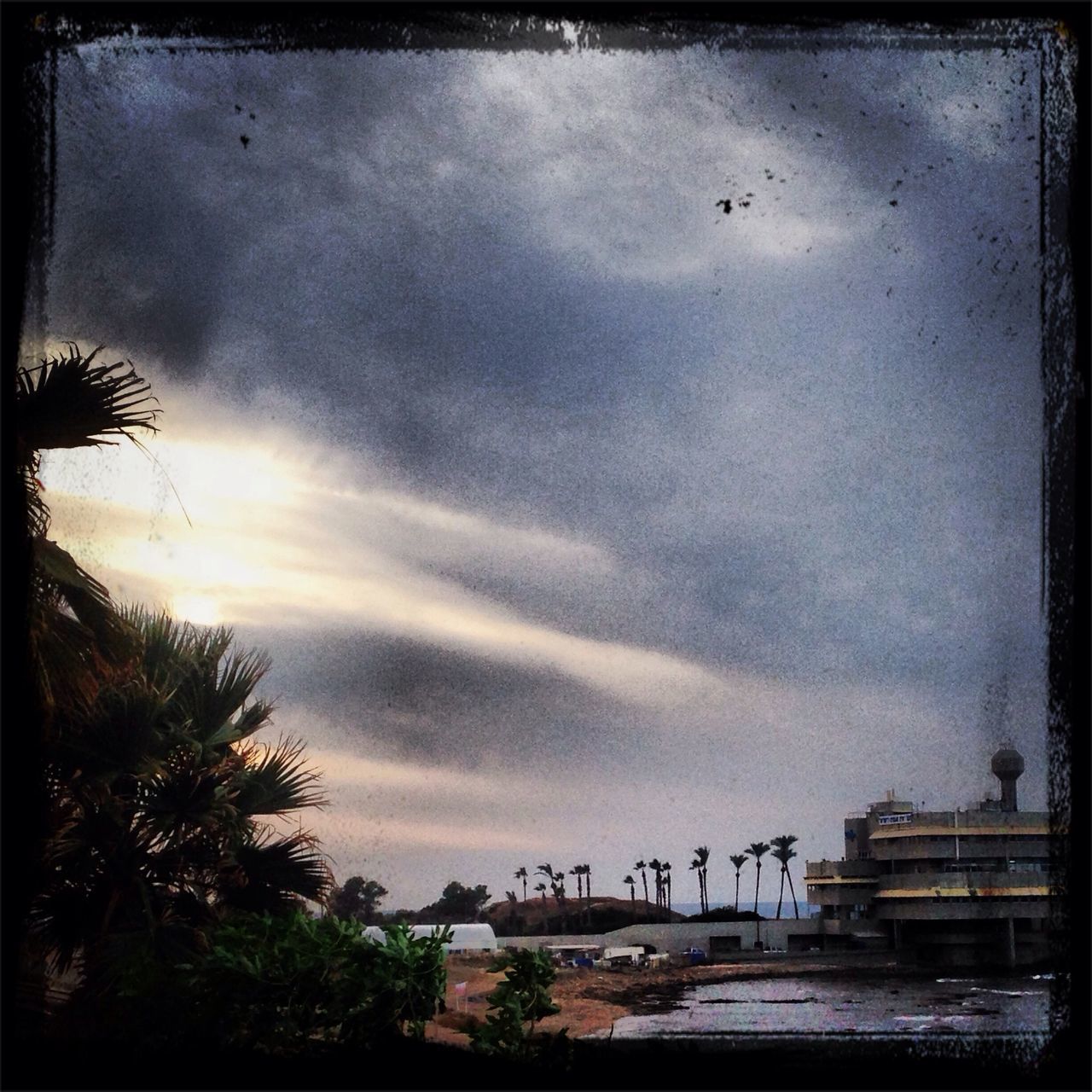 sky, cloud - sky, transfer print, cloudy, auto post production filter, built structure, cloud, weather, overcast, bird, architecture, dusk, nature, water, building exterior, storm cloud, silhouette, scenics, tranquility, beauty in nature