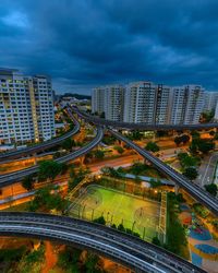 High angle view of road amidst buildings in city against sky