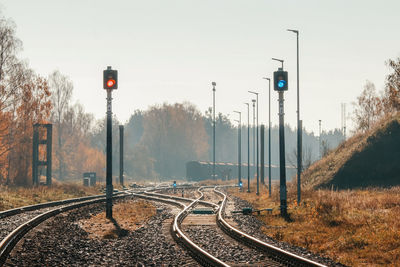 Railroad tracks by trees against sky