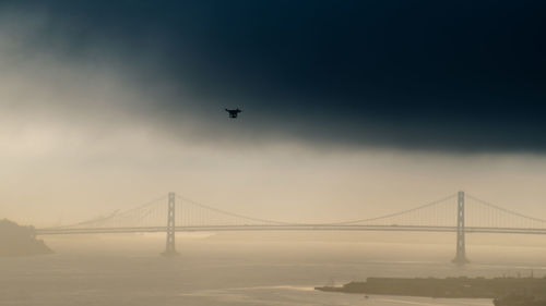 Low angle view of suspension bridge against sky