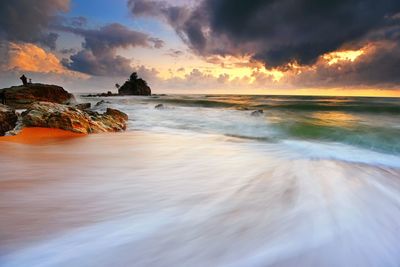 Long exposure of sea and rocks at dusk