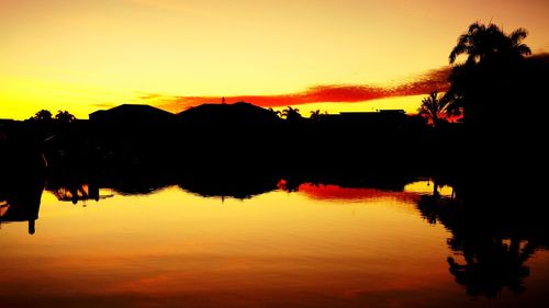 Scenic view of lake against romantic sky at sunset