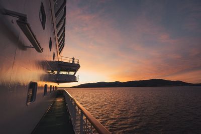 Boat on sea against sky during sunset