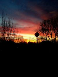 Low angle view of silhouette trees against sky at sunset