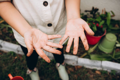 Hands with signs of soil after work in garden