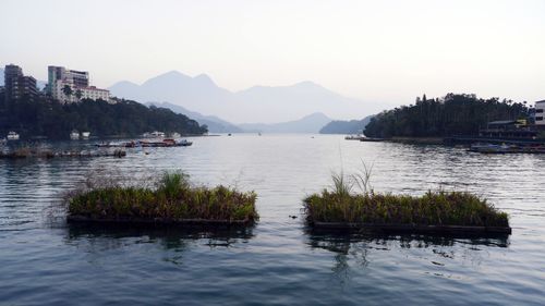 Calm lake against mountain range