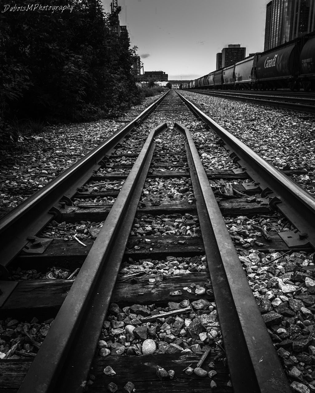 rail transportation, railroad track, transportation, the way forward, surface level, stone - object, connection, straight, auto post production filter, outdoors, diminishing perspective, clear sky, day, vanishing point, railway track, long, railroad tracks, sky, tranquil scene, tranquility, gravel, non-urban scene