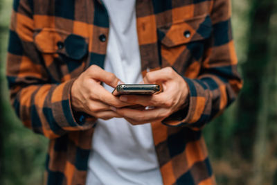 Closeup of young man with mobile phone