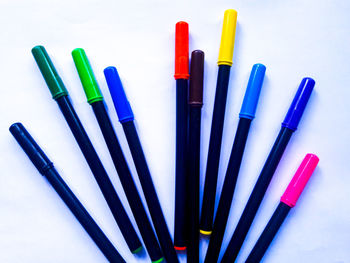 Close-up of colored pencils over white background