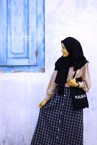 Woman standing at entrance of office building