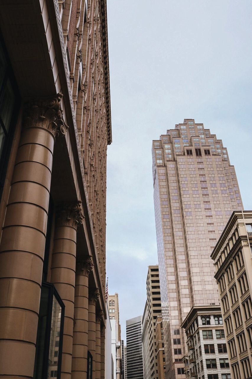 architecture, building exterior, built structure, low angle view, city, sky, building, window, residential building, office building, modern, tall - high, residential structure, skyscraper, day, outdoors, no people, tower, glass - material, city life