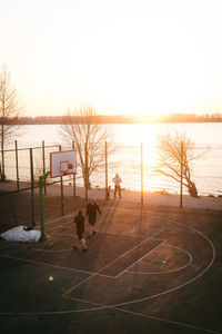 Scenic view of soccer field against sky during sunset