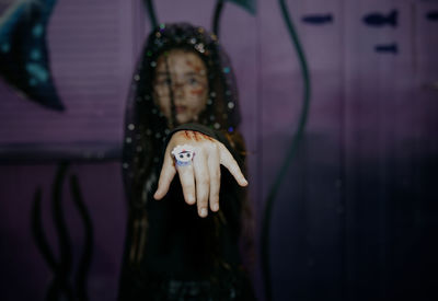 Portrait of a girl with halloween makeup in a witch bride dress.