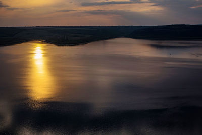 Scenic view of lake against sky during sunset