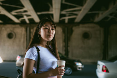 Portrait of young woman standing outdoors