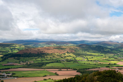 Scenic view of agricultural landscape against sky