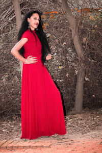 Portrait of young woman standing in forest