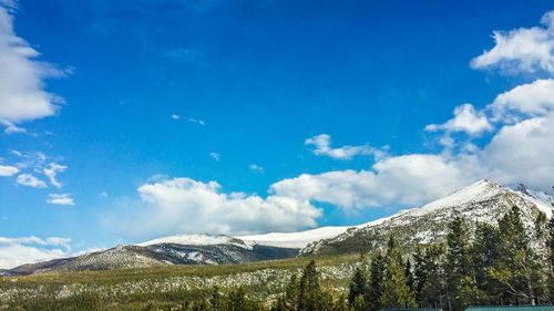 Scenic view of snow covered mountains against sky