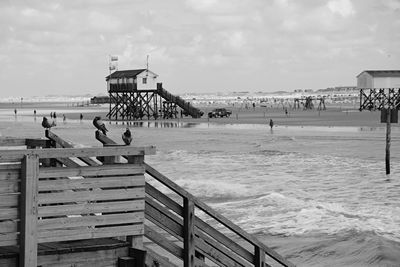 People at beach against sky