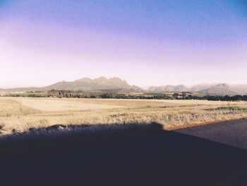 Scenic view of field against clear blue sky