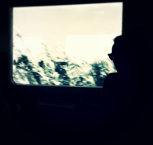 Woman looking through window