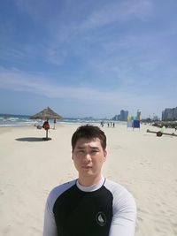 Portrait of man on beach against sky