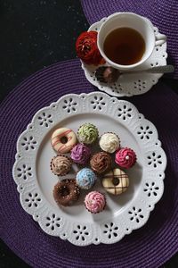 Directly above shot of dessert in plate by black tea on table