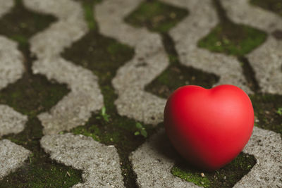 High angle view of red heart shape on footpath