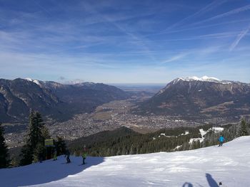 High angle view of people skiing on snowcapped mountains