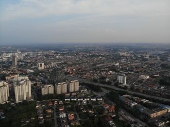 High angle view of city buildings against sky