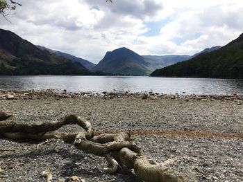 Scenic view of lake against cloudy sky