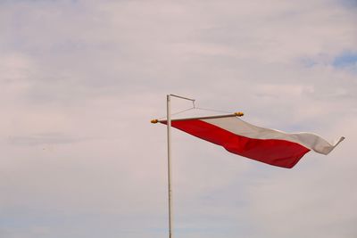 Low angle view of flags hanging against sky