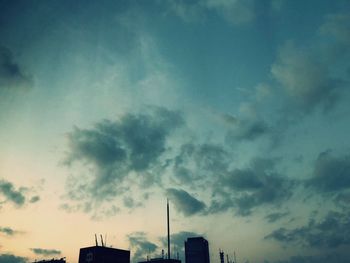 Low angle view of silhouette buildings against sky at dusk