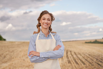 Portrait of a smiling young man standing on field