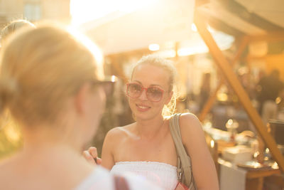 Smiling woman wearing sunglasses standing outdoors