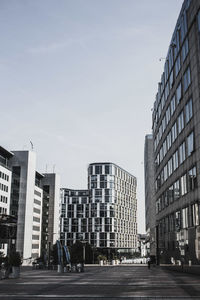 City street and buildings against sky