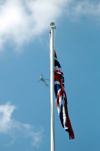 Low angle view of british flag against blue sky