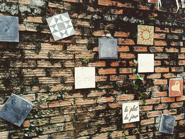 built structure, architecture, building exterior, text, communication, abandoned, wall - building feature, old, brick wall, damaged, obsolete, day, no people, outdoors, western script, wall, run-down, high angle view, weathered, house