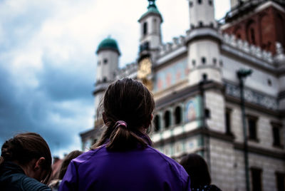 Rear view of woman looking at poznan town hall